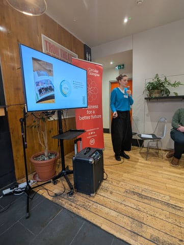 A person standing in front of a screen
AI-generated content may be incorrect.