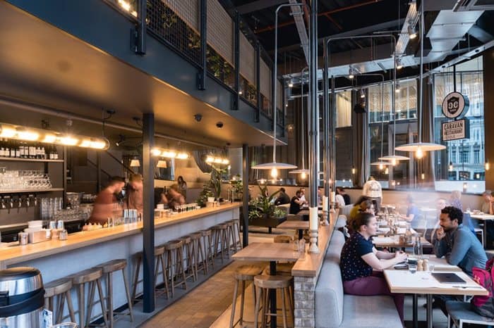 People sitting at tables in a restaurant
Description automatically generated